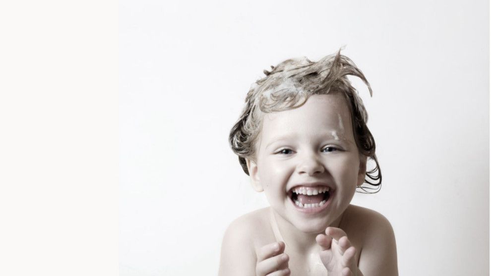 An image of a small child enjoying their bath bubbles, representing the Boots, Unilever and Hygiene Bank campaign