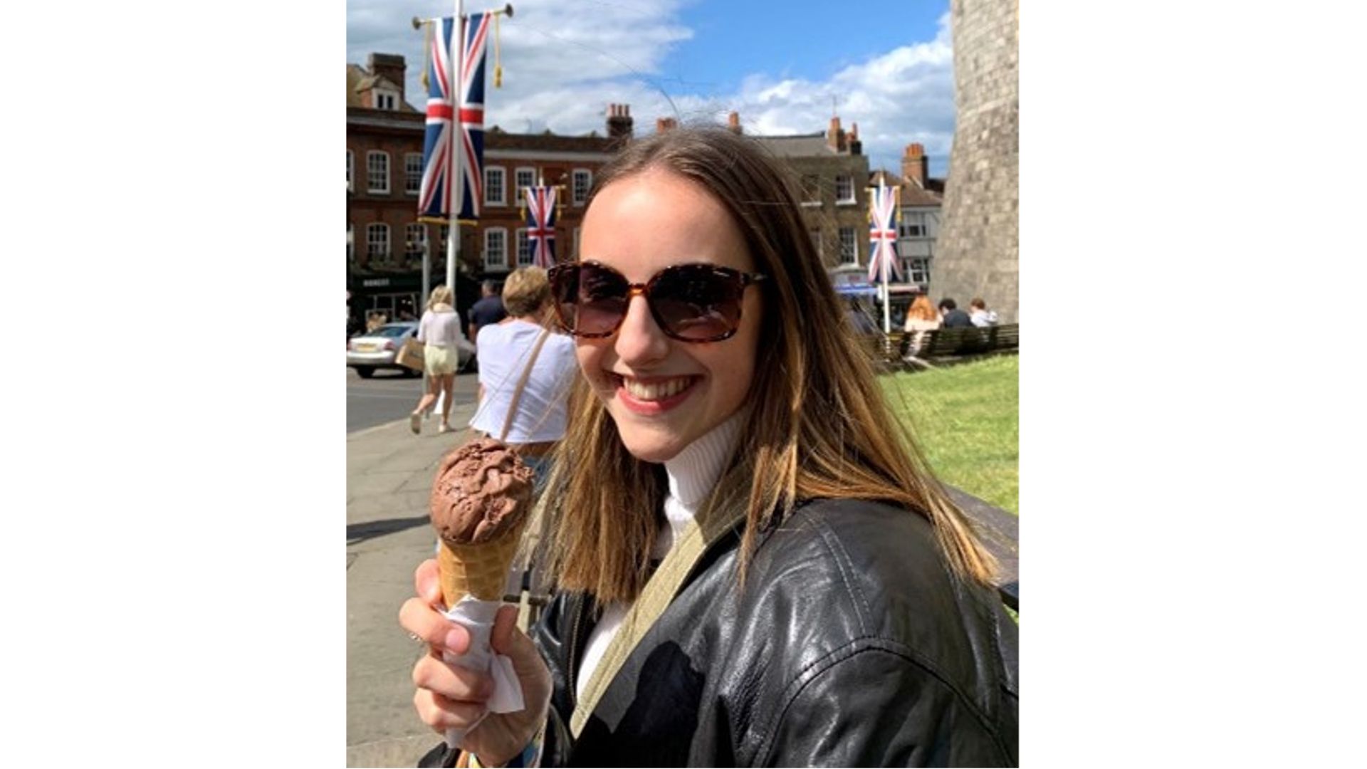 Katy wearing sunglasses and a black leather jacket, holding an ice cream 