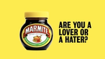 A jar of marmite against a yellow background, with text to the side saying 'are you a lover or a hater?