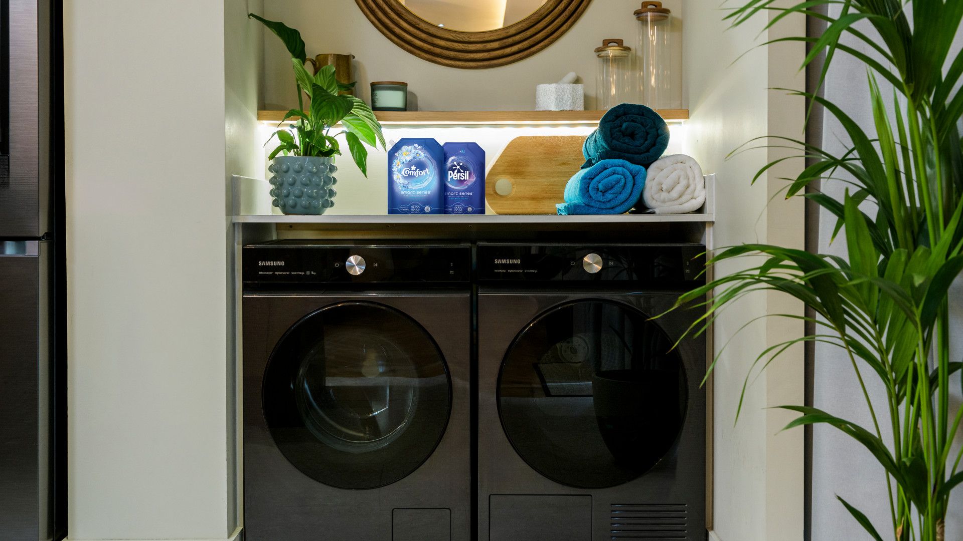 Persil and Comfort Smart Series laundry detergent and conditioner sitting on top of Samsung smart auto-dose washing machine.