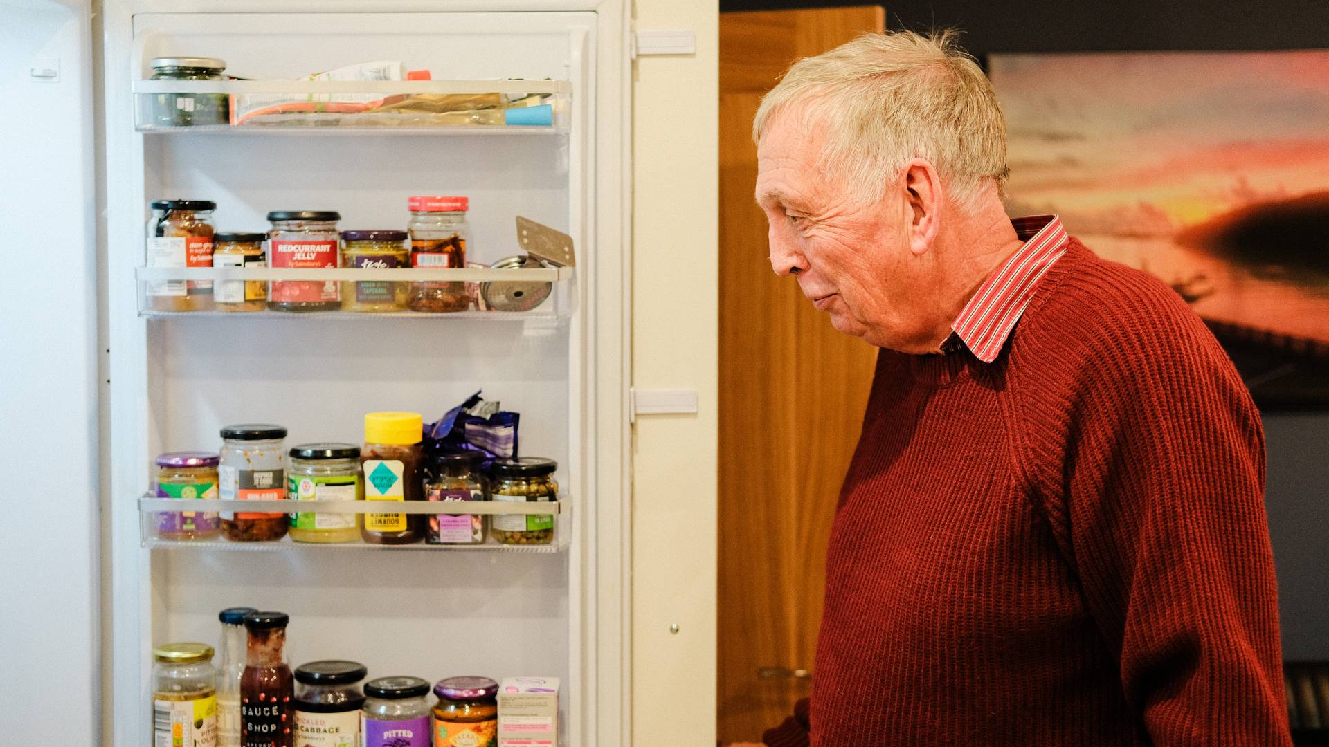 man looking into fridge