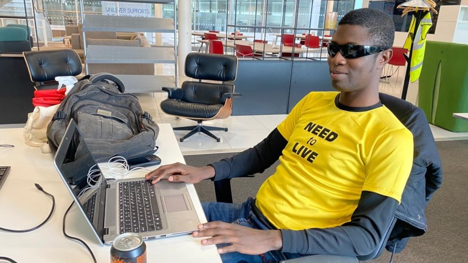 Blind placement student Ademola sat at his desk on his laptop