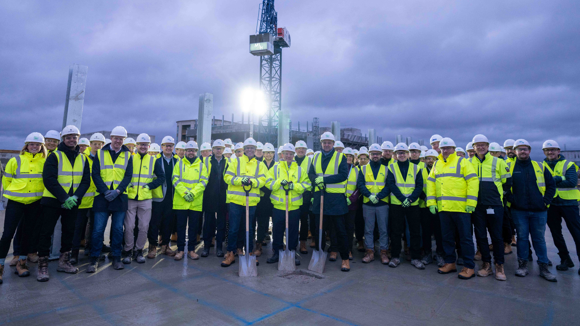 Teams stand at the top of the new Unilever Campus to celebrate topping out 