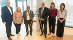 Group of attendees standing beside a commemorative plaque marking the opening of Sunlight House, Unilever's new UK and Ireland headquarters in Kingston upon Thames.