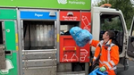 bin man putting a recycling bag into recycle van