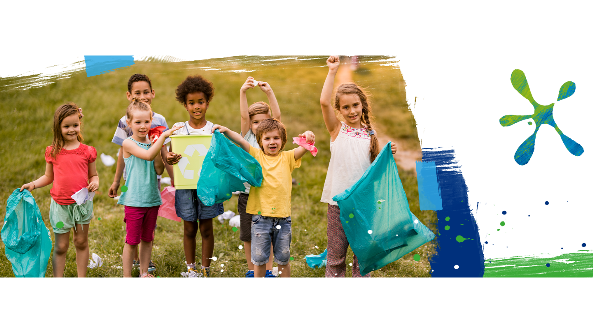 A group of happy children recycling.