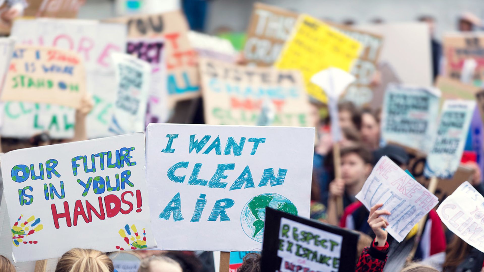 Image of children holding protest placards with Freedom to breathe on them