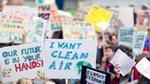 Image of children holding protest placards with Freedom to breathe on them