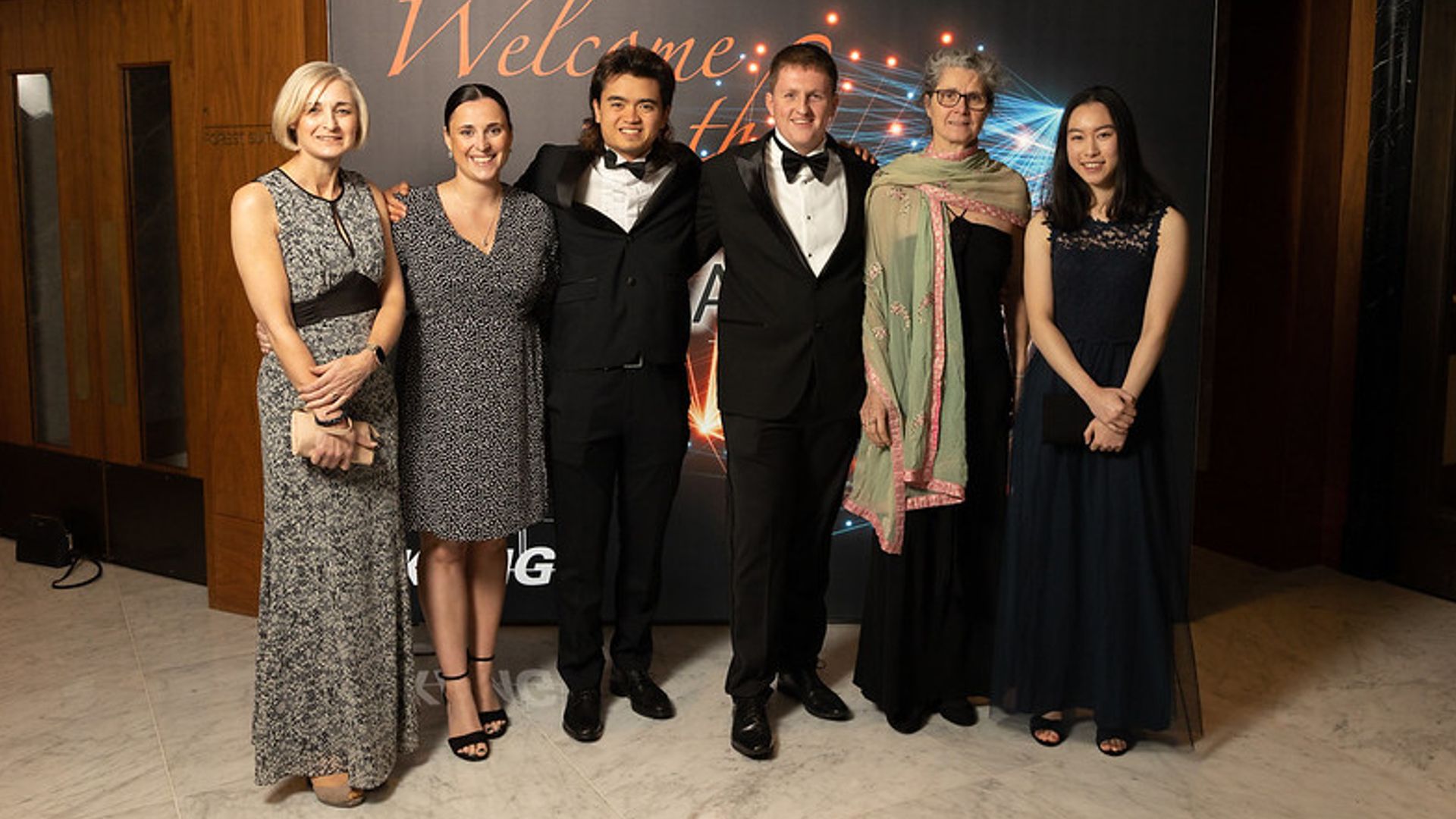 Richard standing with award nominees and award members