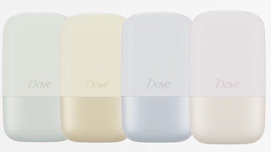 Four Dove deodorant containers in pastel colors: green, yellow, blue, and pink, each with a smooth, rounded design.