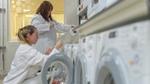 Two female lab technicians running a test in washing machines at Unilever’s world-class laundry detergent Appraisal Lab.