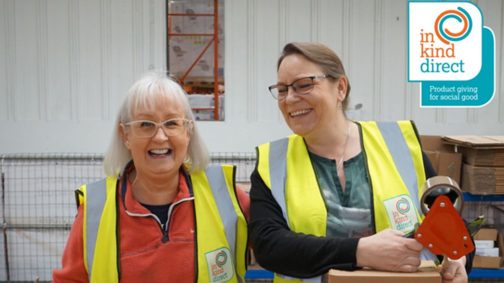 Volunteers smiling in the warehouse of Unilever's charity partner, In Kind Direct